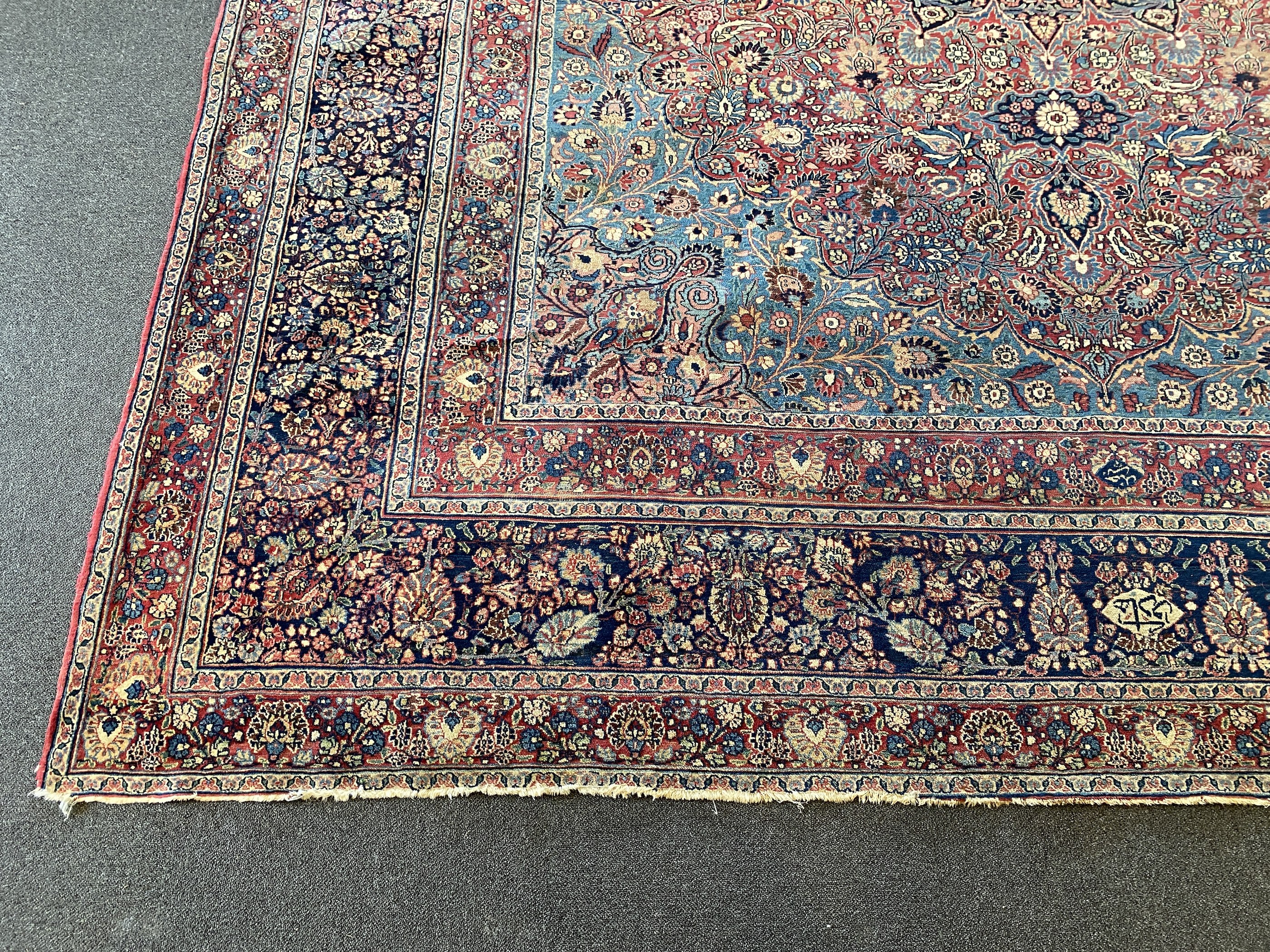 A large Persian blue ground carpet, 395 x 305cm